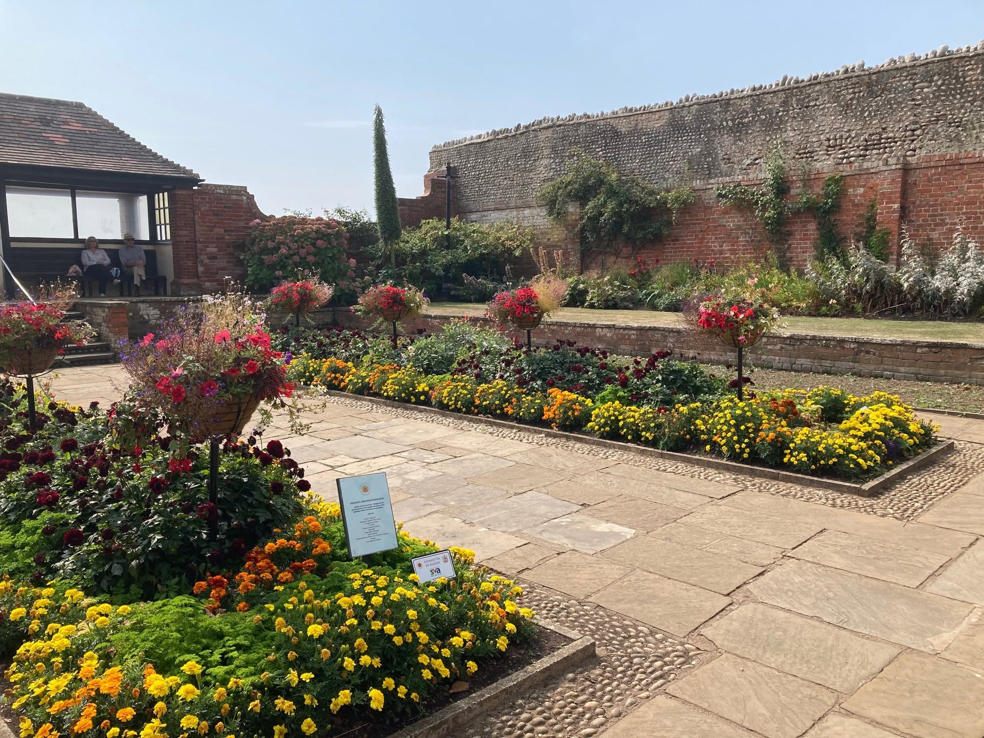 Flower beds and red sandstone walls at Connaught Gardens in Sidmouth