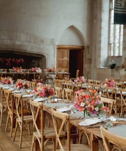 Wedding tables with flowers inside the Great Hall at Dartington