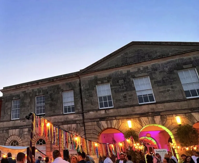 Exeter Castle’s historic courtyard lit up for an evening wedding celebration
