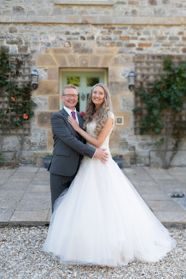 Julie Fox and her husband outside the stone buildings at Glebe Barn