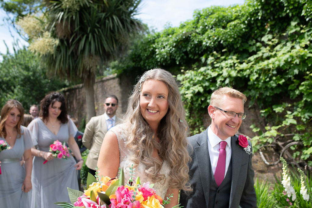 Julie Fox and her husband with guests on their wedding day at Glebe Barn