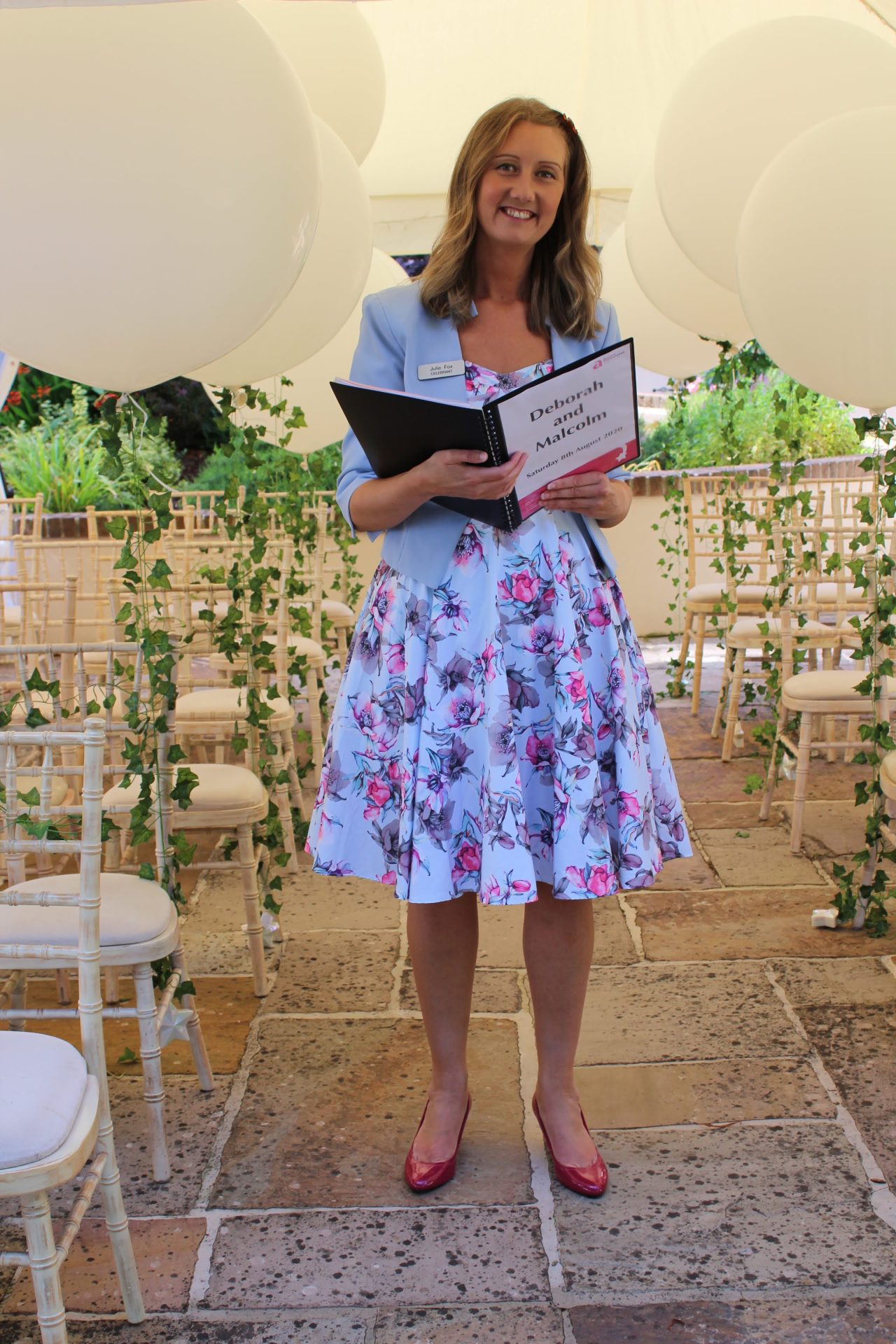 Julie Fox holding her ceremony script before a wedding
