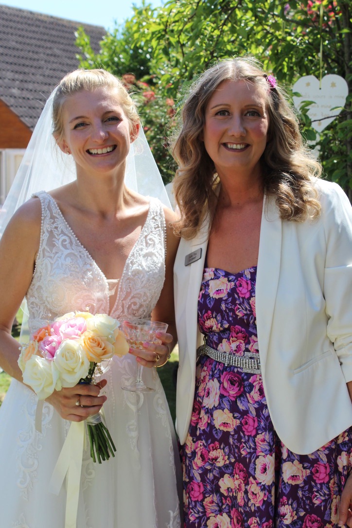 Julie Fox with a smiling bride after a wedding ceremony