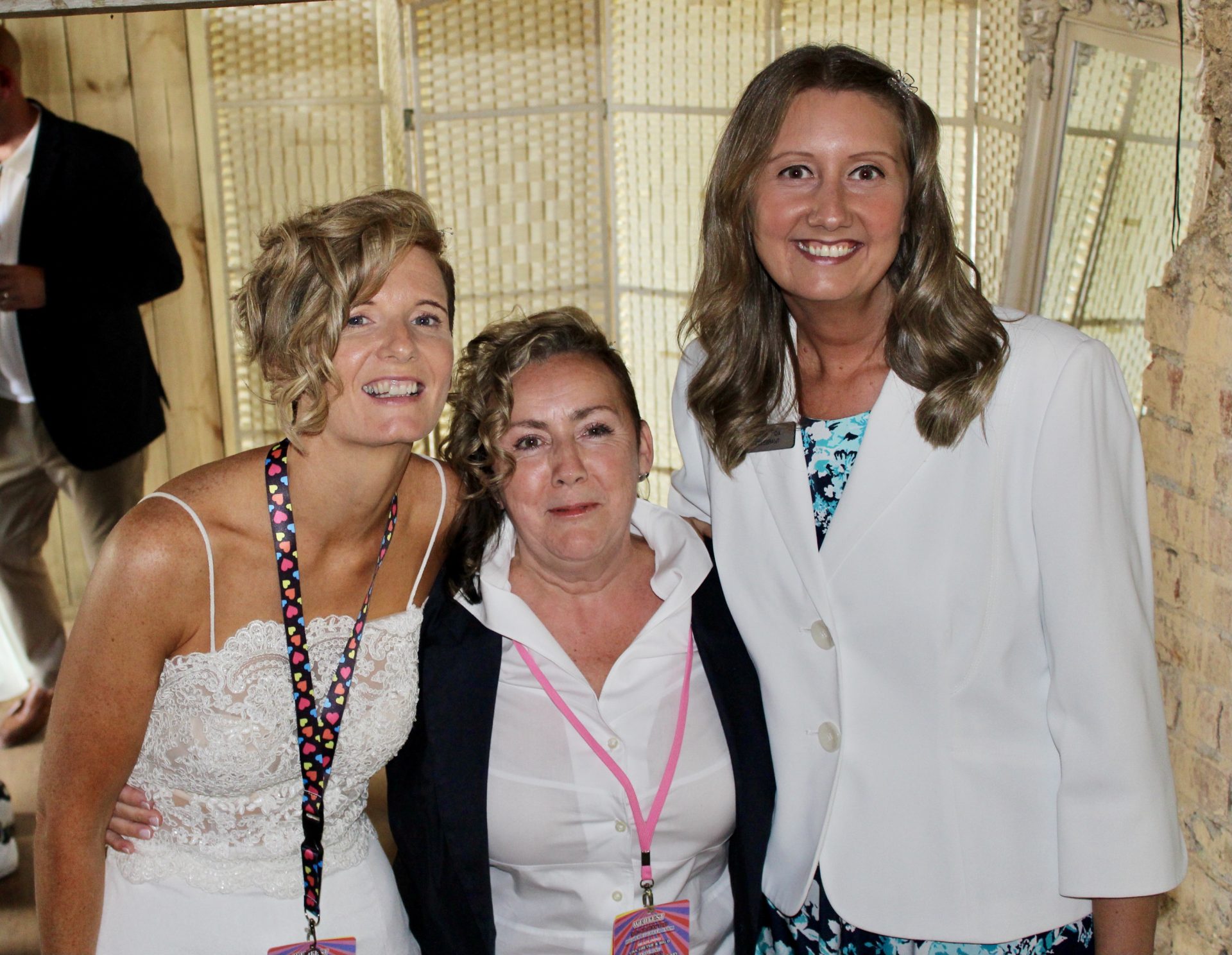 Julie Fox with a smiling couple after their wedding ceremony