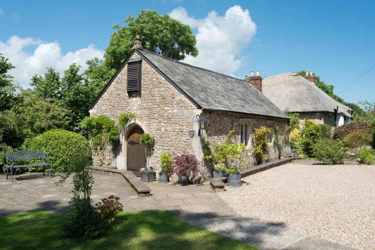 Lady Margaret’s Medieval Hall, a stone-built hall with a gravel courtyard and gardens