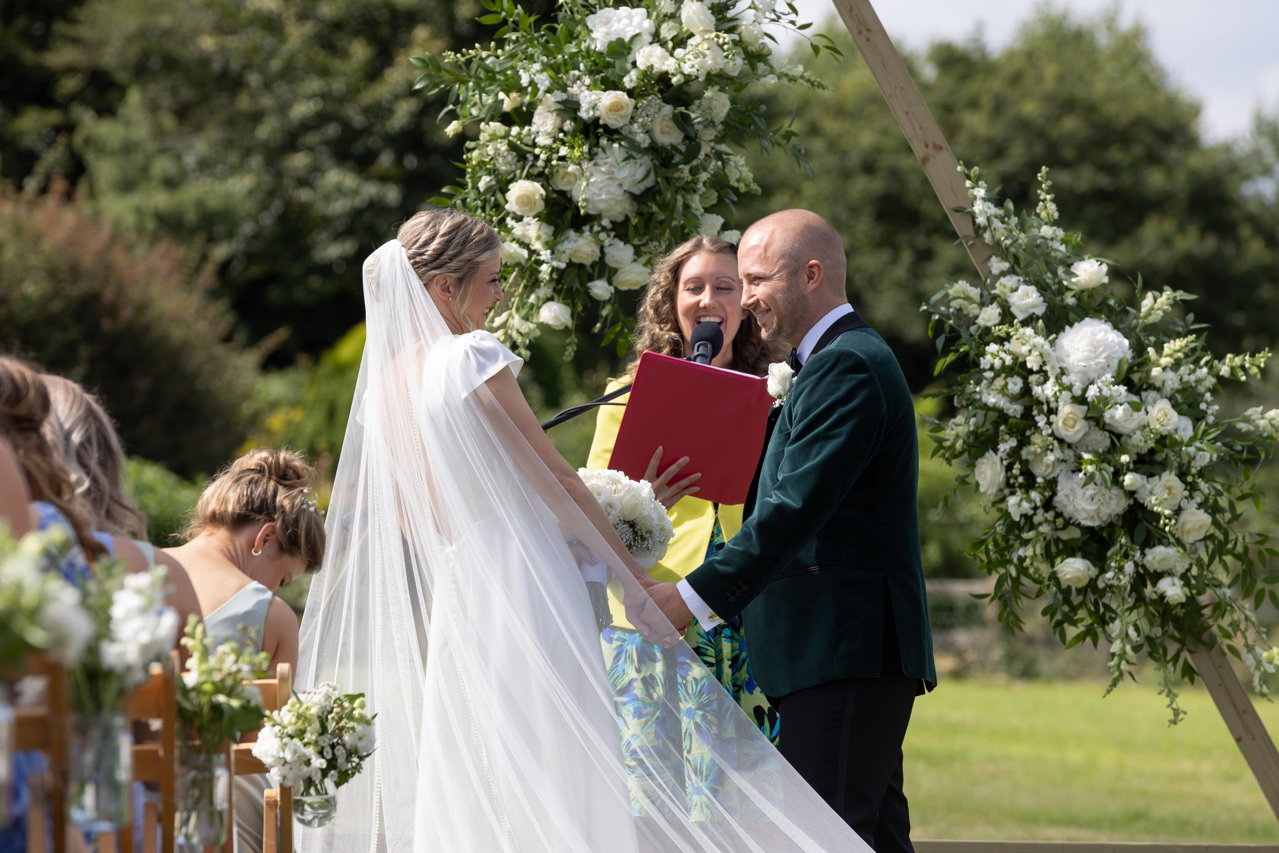 Lucy and Beau at the floral arch with Julie Fox, Stoodleigh
