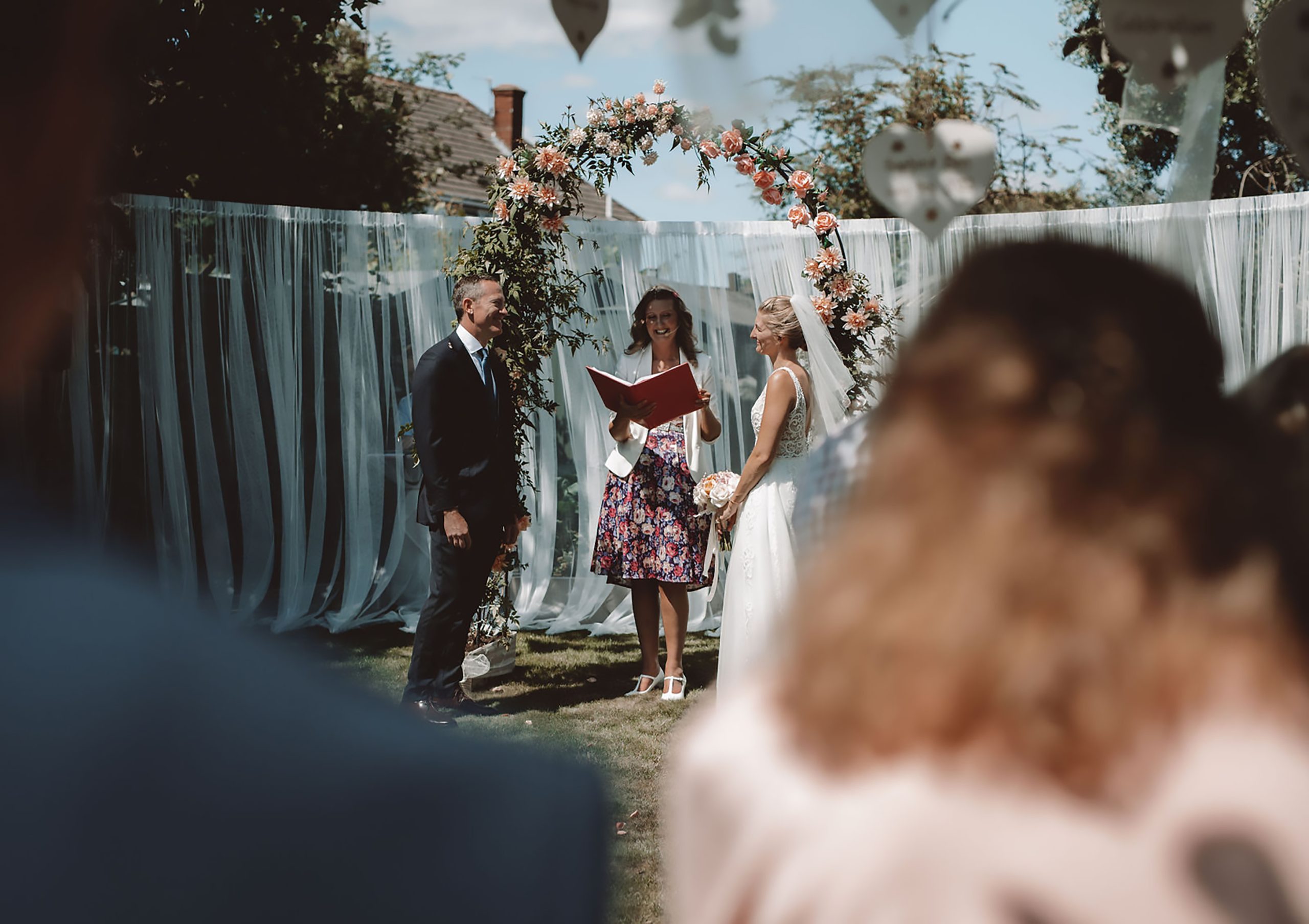 Julie Fox leading Sophie and Ben's garden wedding ceremony in Exmouth